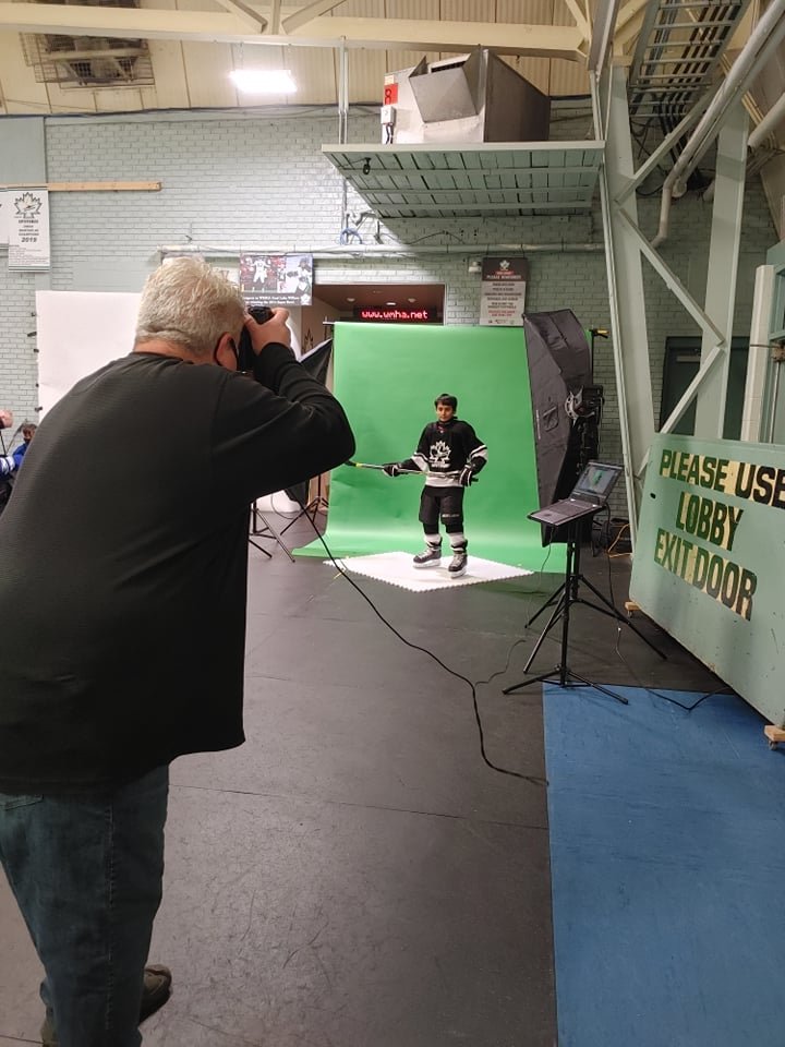 DraftPics photographer working with an athlete during PhotoDay