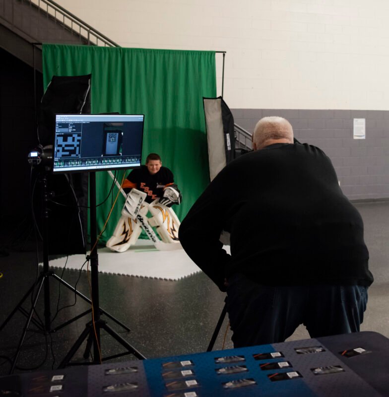 DraftPics photographer working with an athlete during PhotoDay